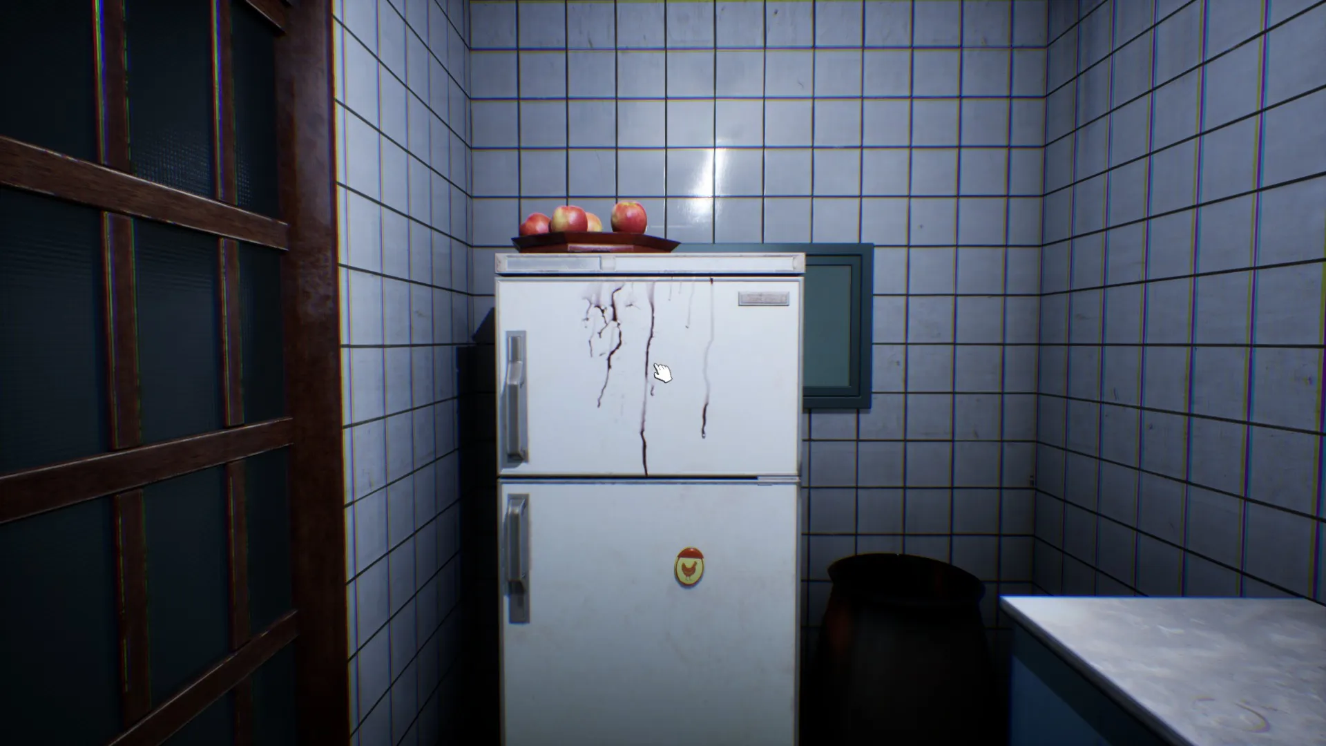 The freezer compartment handle is covered in blood.