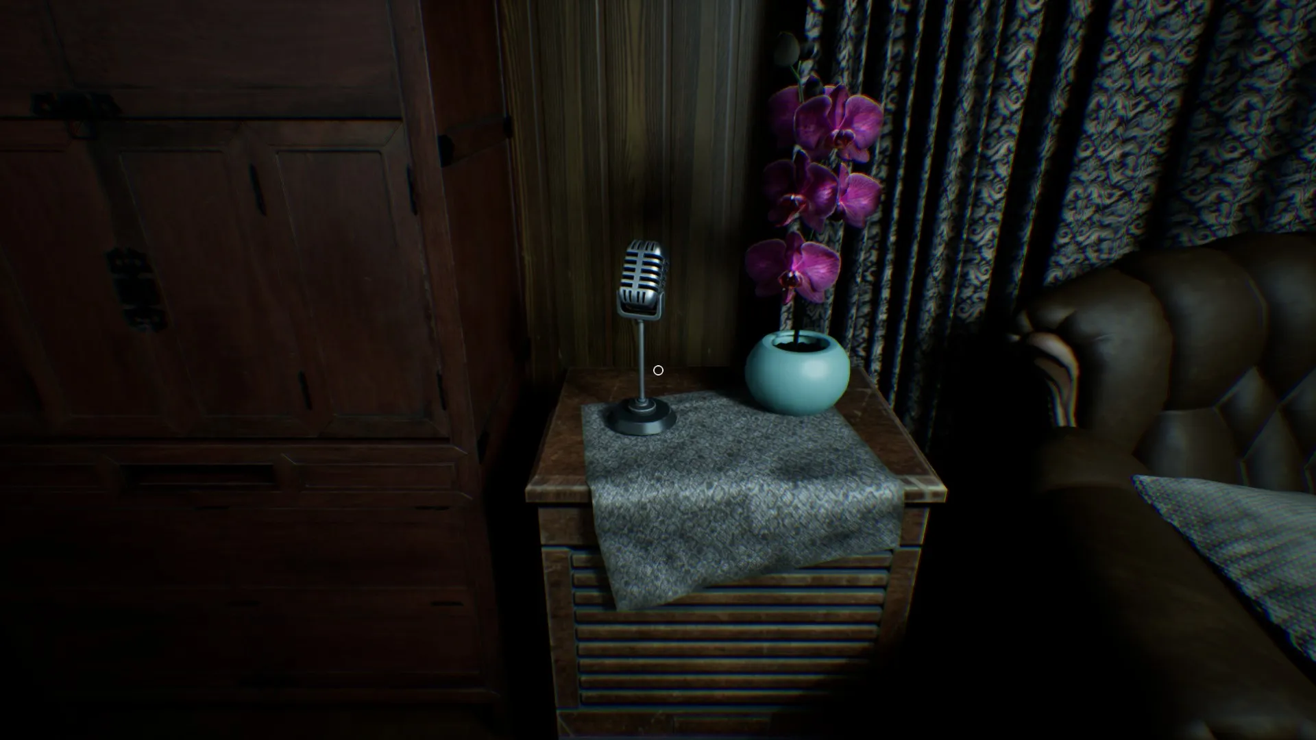 Mori's doll has moved and is now peeking out from behind the microphone.